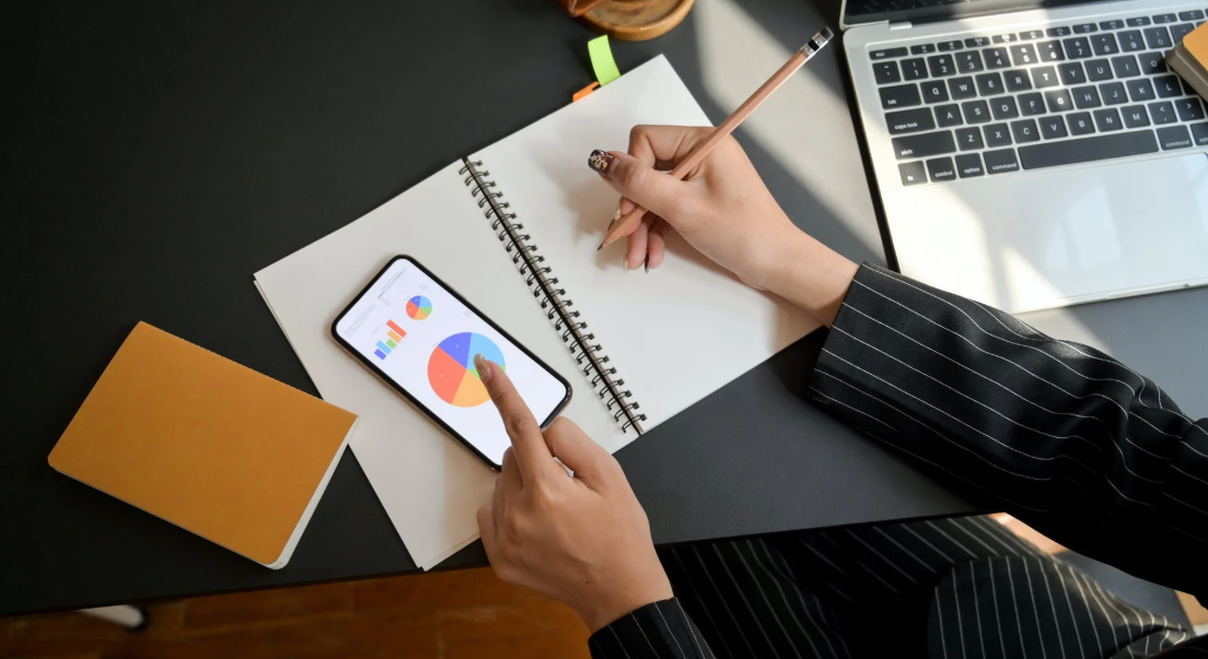 wireframe planning on notebook with phone